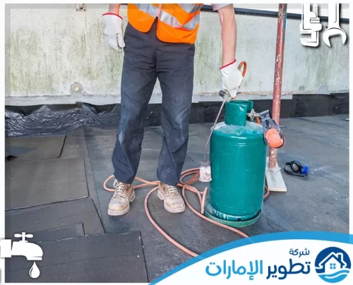 عامل صيانة يقوم بتطبيق العزل على الأسطح لضمان مقاومة المياه والحرارة.